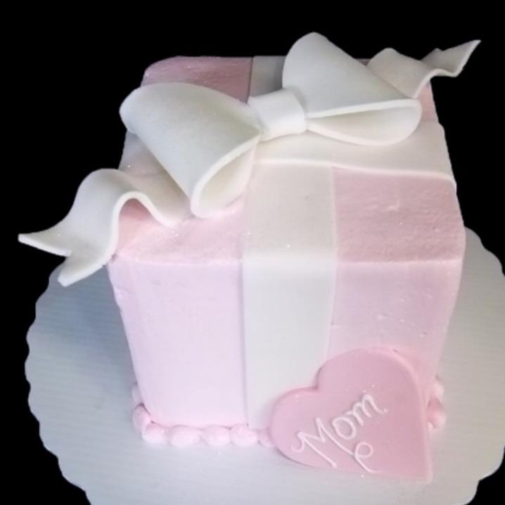 Small square cake shaped like a present with a bow