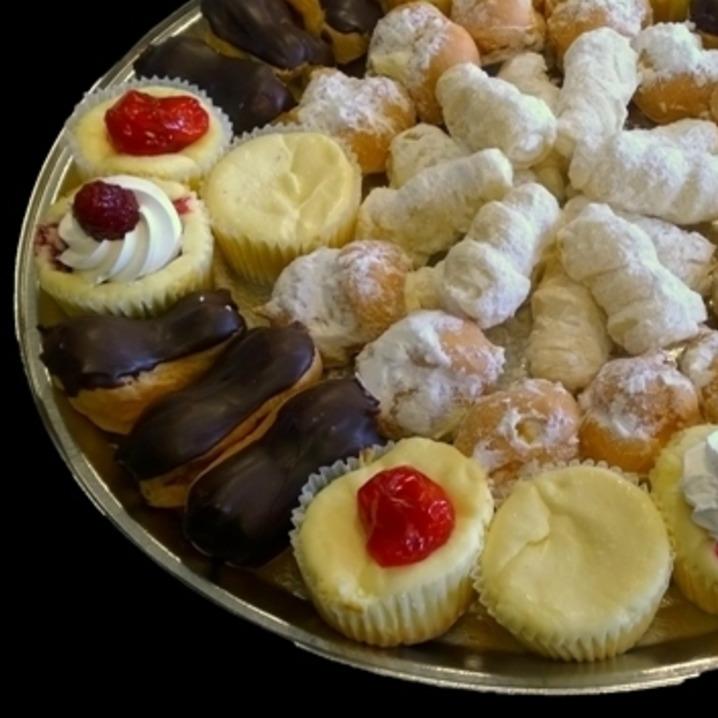 Assorted mini pastries on a tray.