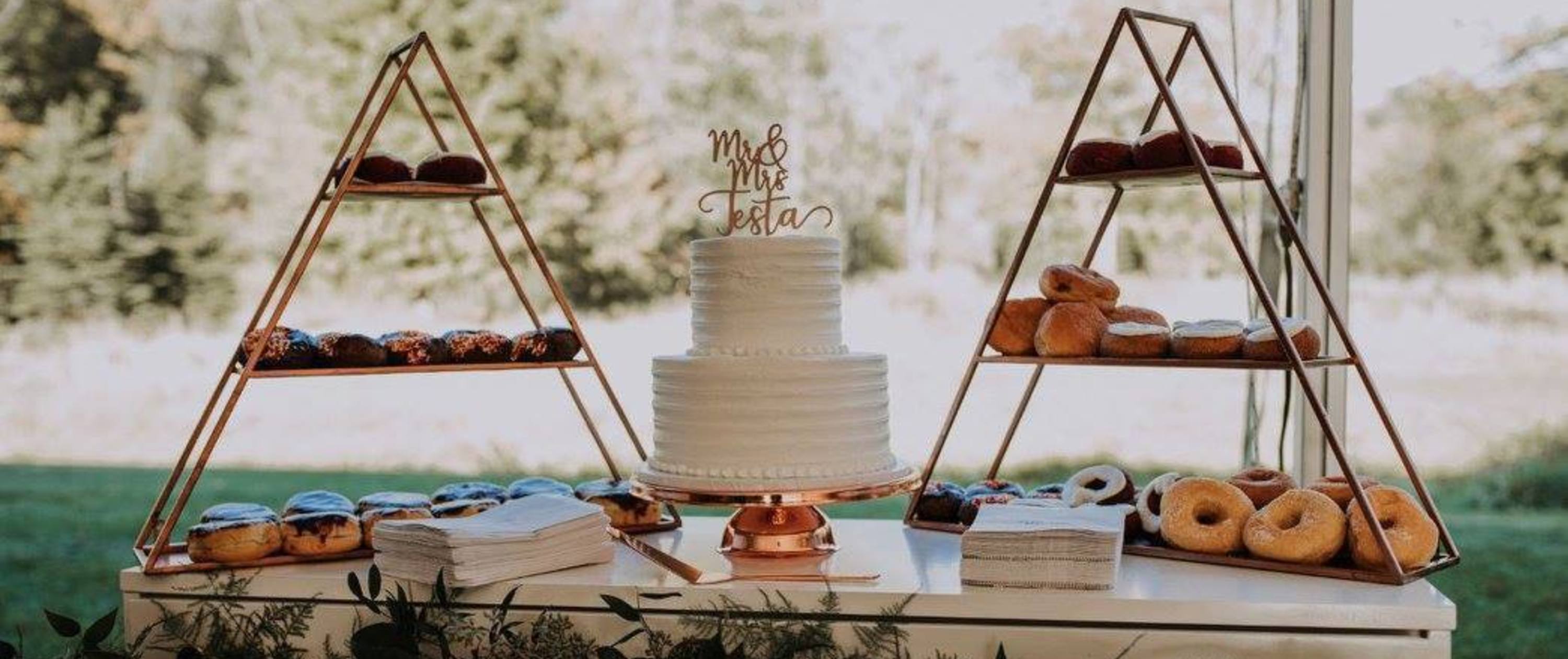 Donut and wedding cake table at a wedding