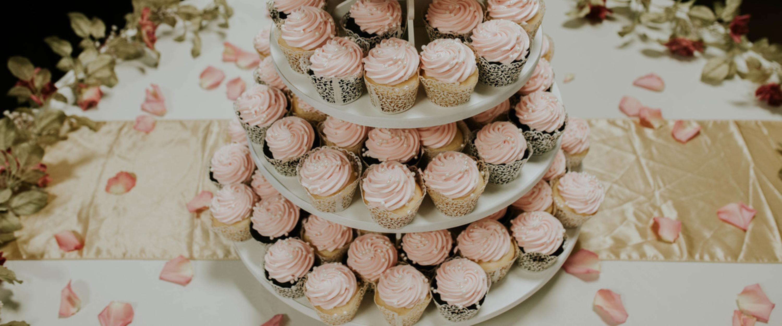 Delicate pink cupcakes with pearls and floral accents