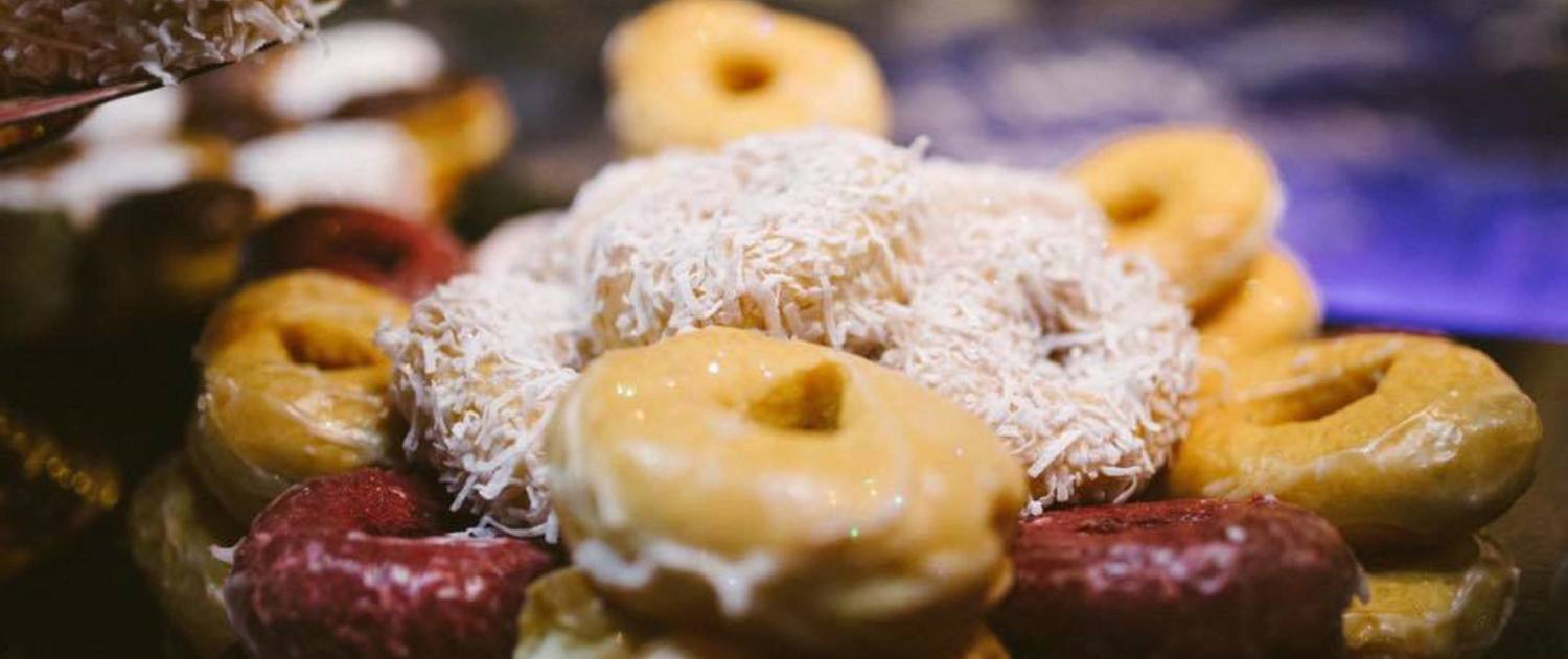 Assortment of glazed and sprinkled donuts on a tray